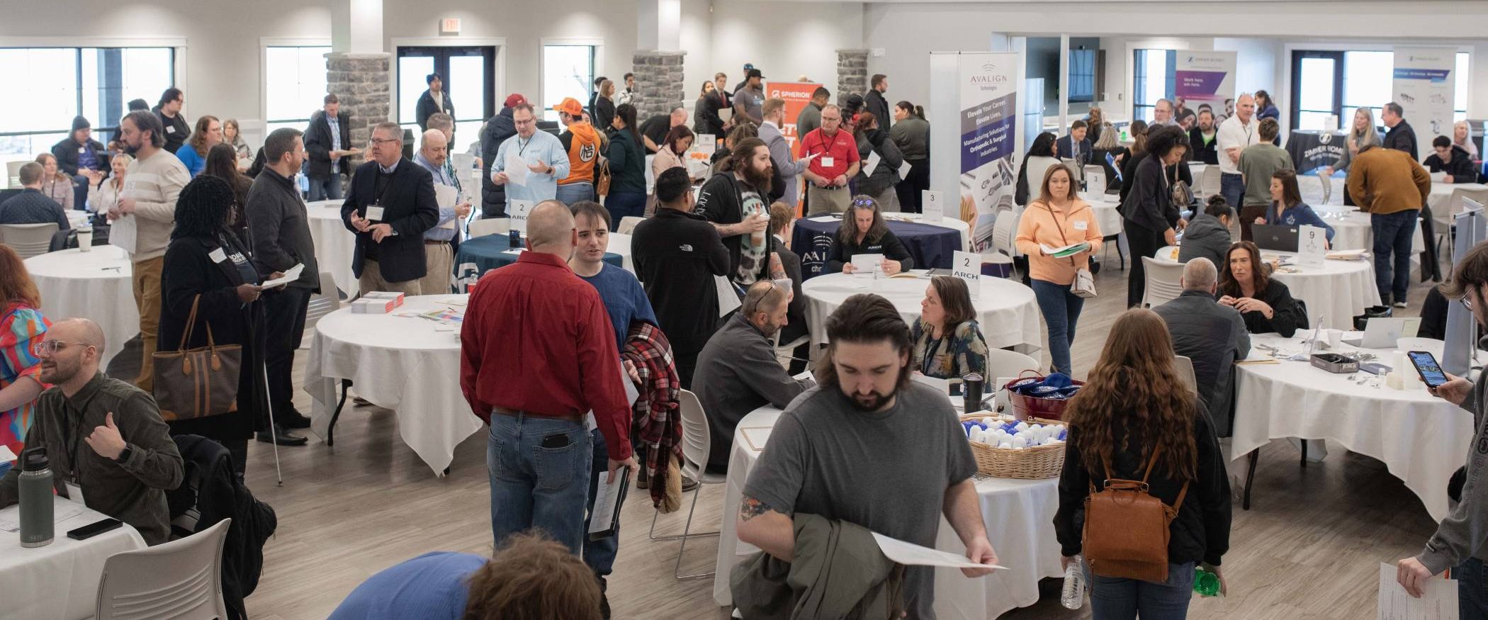 Room full of people participating in community wide hiring event